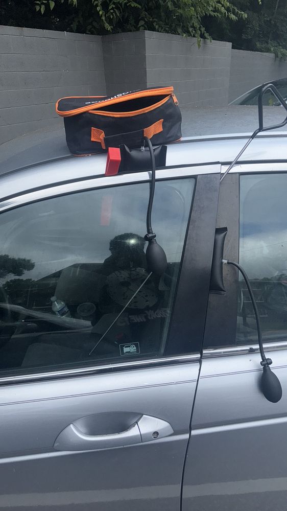 Car lockout service in Richmond VA using air wedge and reach tool on a locked sedan door
