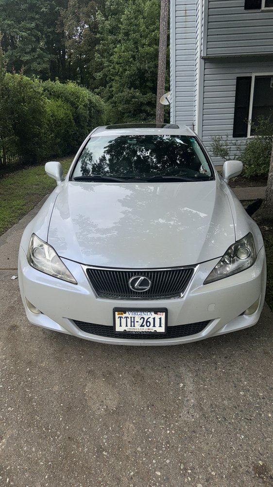 White Lexus IS assisted in a driveway during a roadside assistance service call